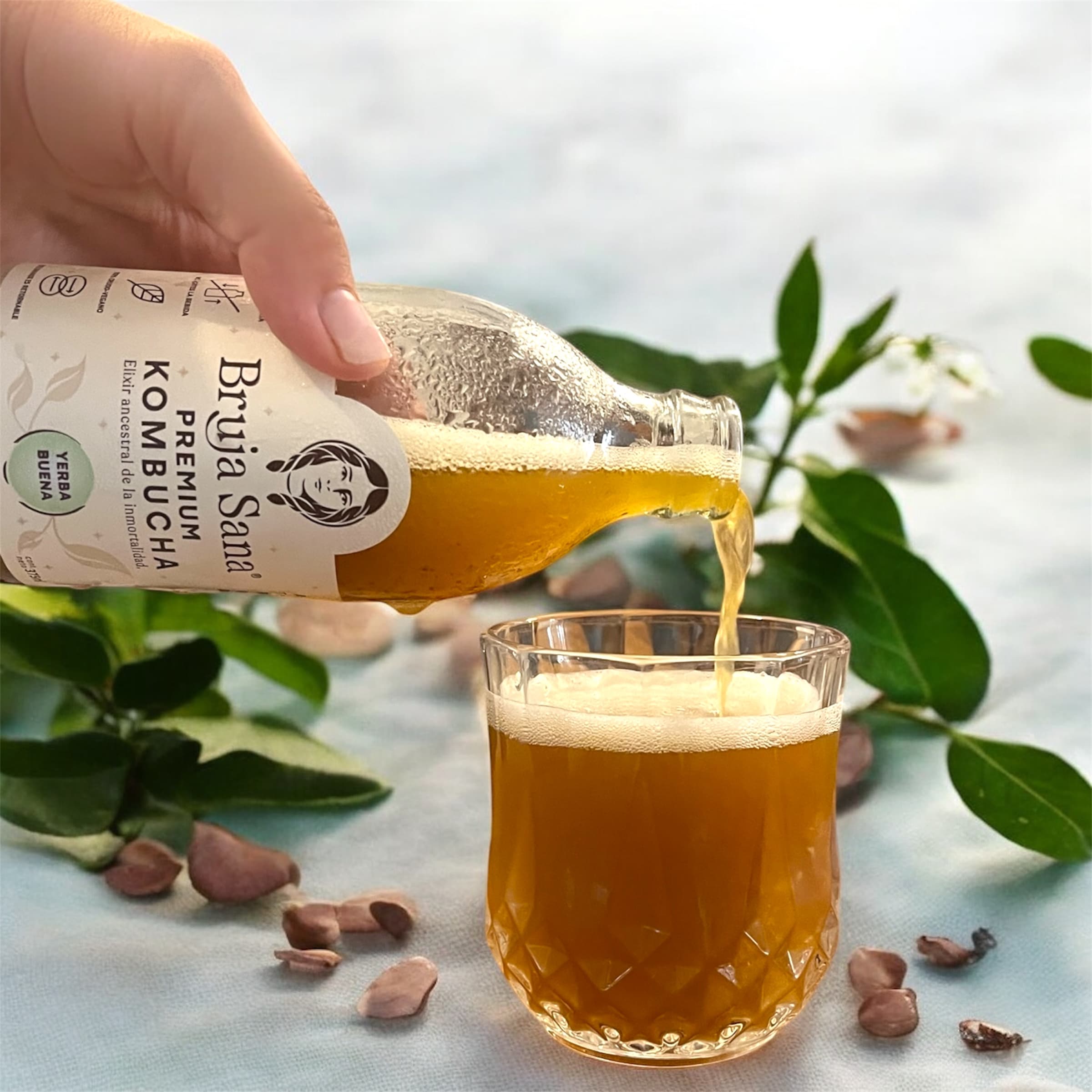 Pouring a Bruja Sana kombucha