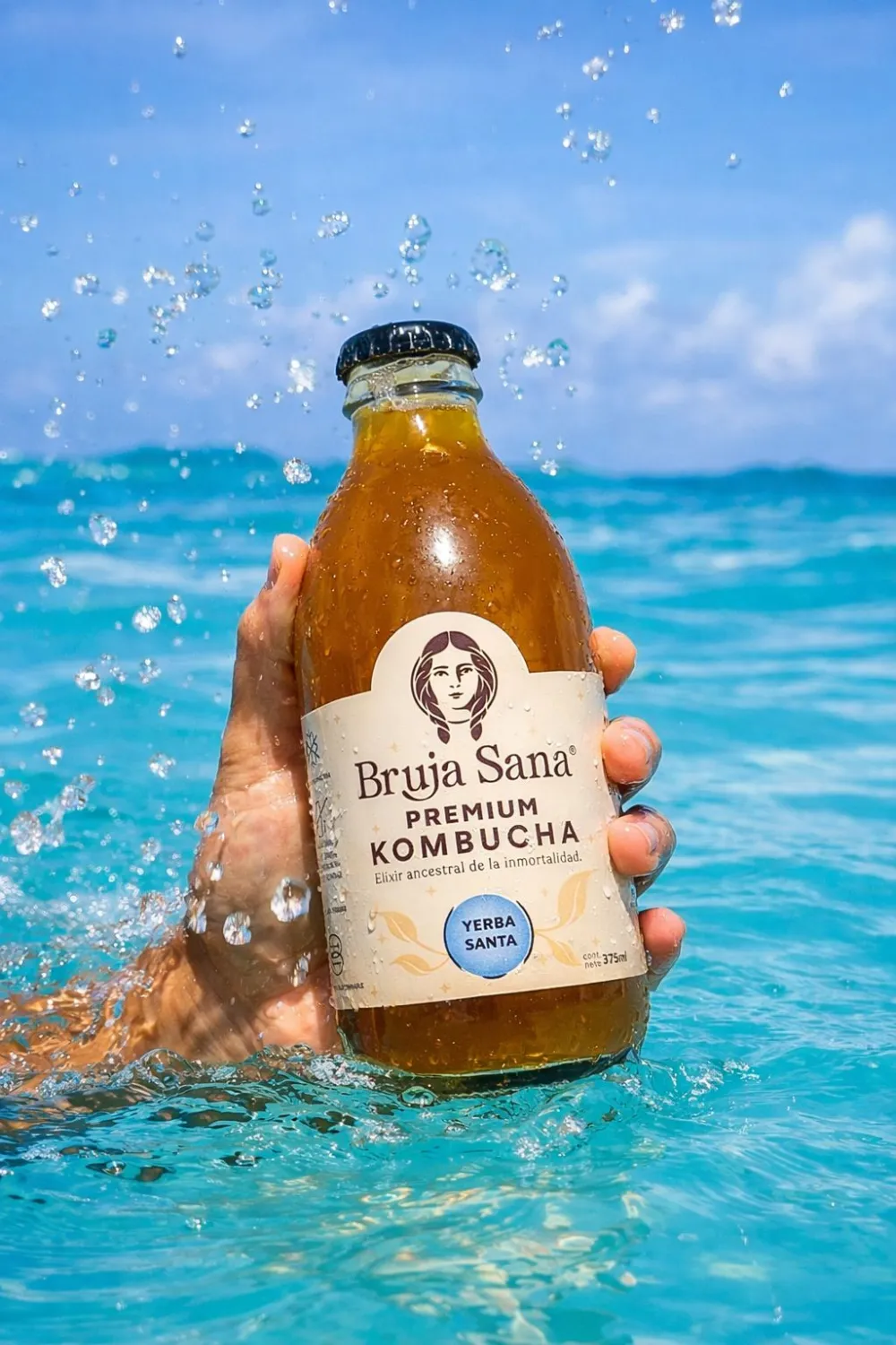A Bruja Sana bottle lifted from the turquoise Caribbean sea